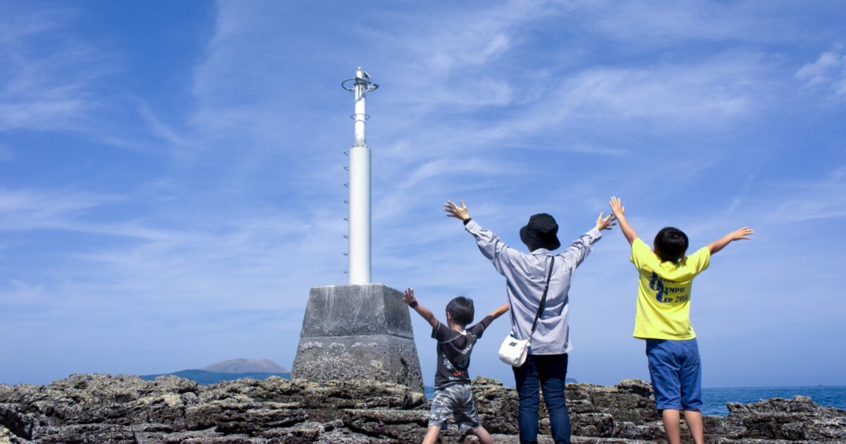海辺の岩場でポーズをとる親子