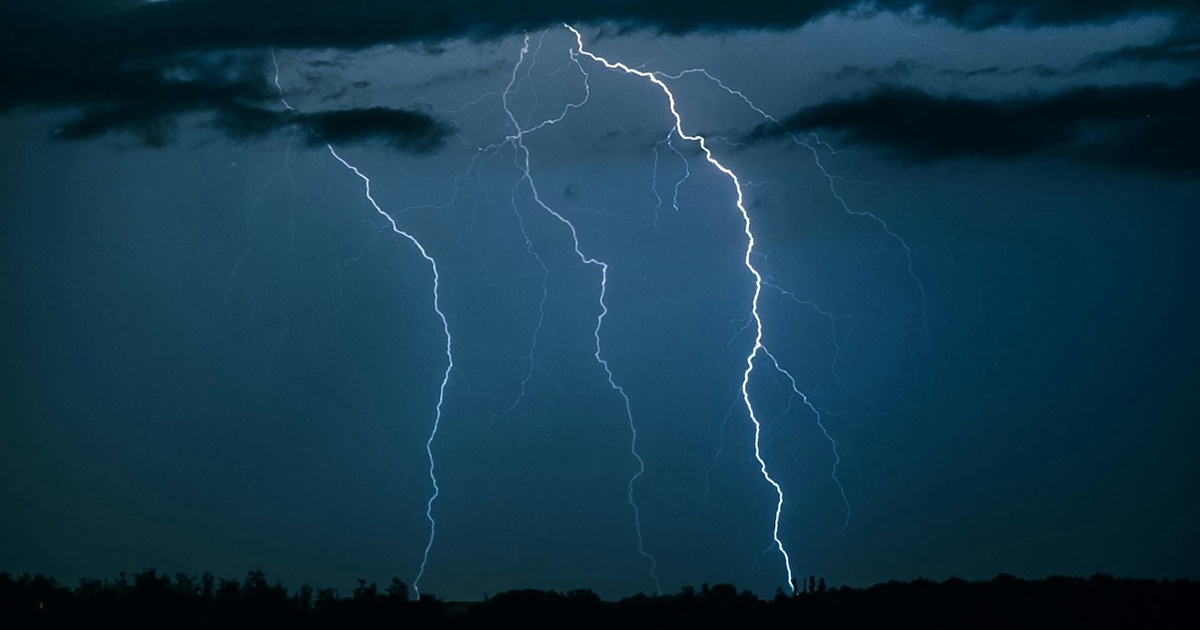 暗闇の中に光る複数の落雷と雲に覆われた空