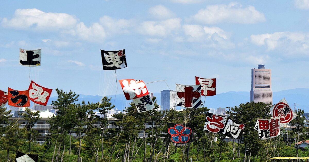青空に舞う凧と都市の風景